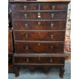 A late 17th/18th century oak chest on stand, the two short over four long graduated drawers with