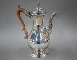 A George III silver pear-shaped coffee pot, the domed lid with writhen flame finial, with