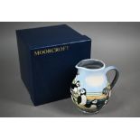 A boxed Moorcroft 'Puffins' jug by Carol Lovett, 14 cm