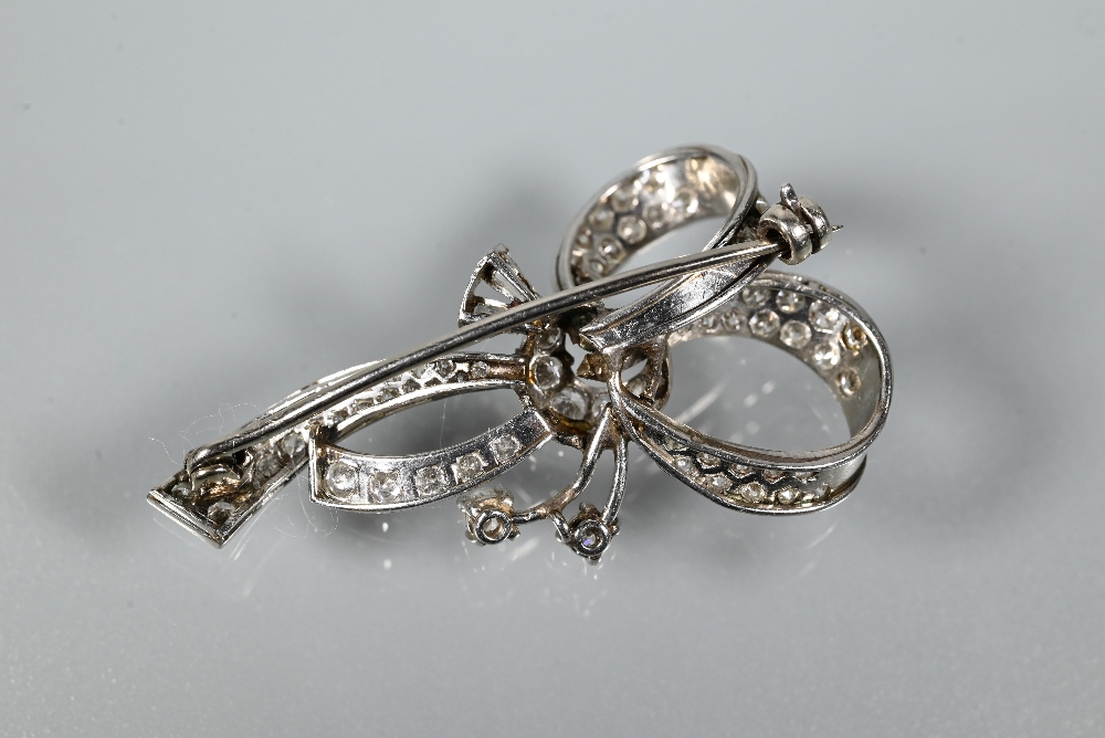 A diamond brooch, the white metal set overall with mixed cut diamonds in the style of a loosely-tied - Image 3 of 3