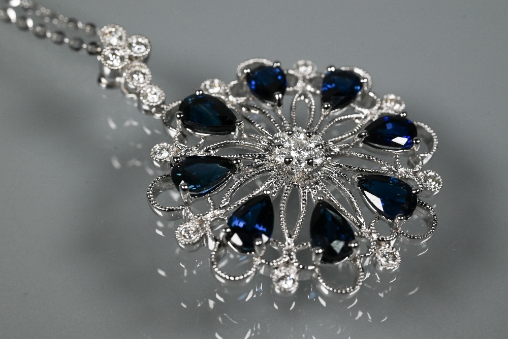 A sapphire and diamond pendant, the open circular millgrain wirework flower-style mount set with - Image 3 of 5