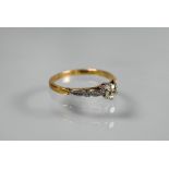 A single stone diamond ring, the claw set diamond of pale yellow hue in 18ct yellow and white gold