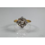 An antique diamond cluster ring formed of nine mixed cut diamonds, yellow and white gold set, size M