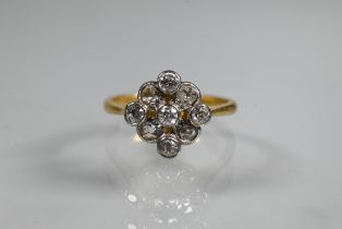 An antique diamond cluster ring formed of nine mixed cut diamonds, yellow and white gold set, size M