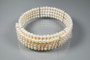 A pearl choker, the four rows of cultured pearls on flexible wire core, approx 15 cm (max)