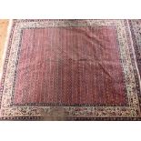 A pair of old close matching Persian carpets, the brown-red ground with stylised designs, of
