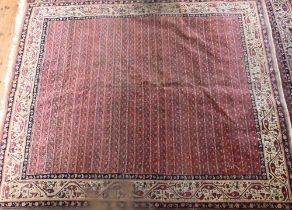 A pair of old close matching Persian carpets, the brown-red ground with stylised designs, of