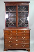 A George III mahogany secretaire bookcase, the dentil moulded cornice over a pair of astragal glazed