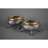 A pair of George III silver oval salts with floral chased decoration and hoof feet (maker's mark