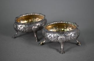 A pair of George III silver oval salts with floral chased decoration and hoof feet (maker's mark