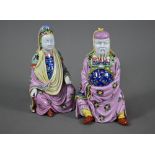 A pair of Dresden figures of a Chinese couple in pink official's robes painted with flowers and