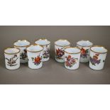 A matched set of eight 19th century Continental opaque glass beakers, individually painted with