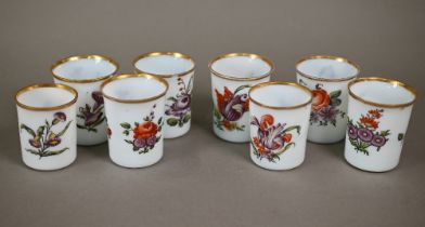 A matched set of eight 19th century Continental opaque glass beakers, individually painted with