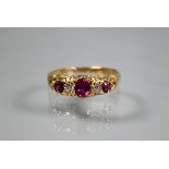 An antique five stone ruby and diamond ring, the graduated stones in 18ct yellow gold setting,