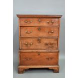 An 18th century oak chest on stand, of diminutive proportions comprising three long graduated