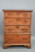 An 18th century oak chest on stand, of diminutive proportions comprising three long graduated