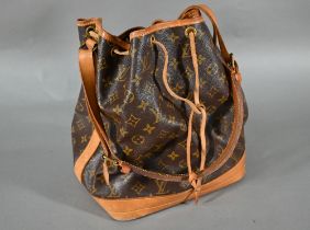 A Louis Vuitton leather tote bag with drawstring fastening and single strap handle