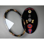 A Japanese ovoid gilt and black lacquered medals display case ontaining assorted military/Shooting