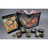 Seven Russian kholui lacquer boxes and a brooch, painted in miniature with scenes from traditional