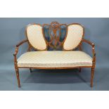 An Edwardian Sheraton Revival floral polychrome decorated satinwood sofa, with fabric back panels