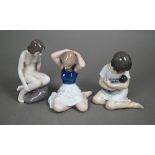 Three Royal Copenhagen seated figures - 1938 Girl with Doll, 4027 Girl on Rock and 4648 dancer