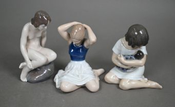 Three Royal Copenhagen seated figures - 1938 Girl with Doll, 4027 Girl on Rock and 4648 dancer