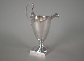A George III silver cream jug in the Adam style, with beaded rim and scroll handle, on stemmed