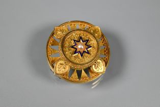A Victorian gold roundel brooch in the neo-classical manner, the central blue enamel star with
