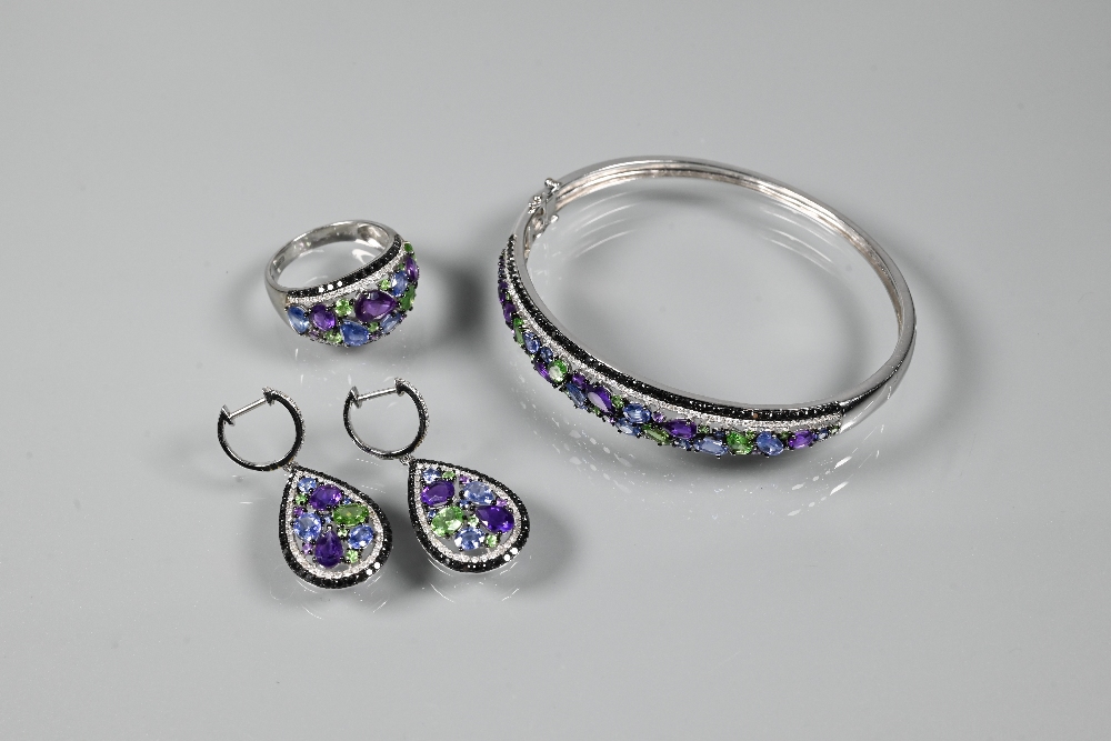 A suite comprising half-hinged bangle, bombe-style ring and pendant drop earrings, each set with
