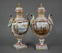 A pair of 19th century French porcelain vases, the domed covers with fir-cone finials, the twin