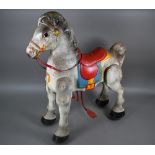 A 1950s Mobo Bronco toy horse, the painted pressed steel body complete with red plastic reins and