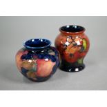 A vintage Moorcroft small baluster vase, decorated with 'orchid' pattern on flambé ground, 8 cm to/w