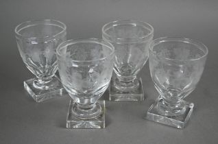 A set of four Regency glass rummers with vine etched decoration on squat stems and heavy square