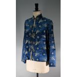 A Chinese navy blue silk mandarin-style jacket with shaped collar and buttons to front, sheepskin-