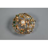 A circular brooch of open floral form, set with central cultured pearl and with six small cabochon