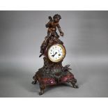 An antique French rouge marble spelter mounted mantel clock, the 8-day two train movement by Moulin,