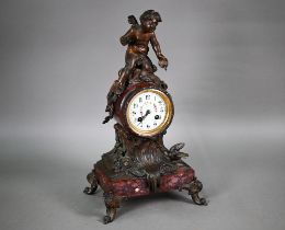 An antique French rouge marble spelter mounted mantel clock, the 8-day two train movement by Moulin,