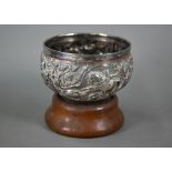 An Indian heavy quality white metal bowl, richly embossed and chased with hunting scenes, soldiers