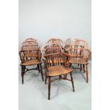 A well matched harlequin set of seven yew and elm seat low splat back Windsor armchairs, 19th