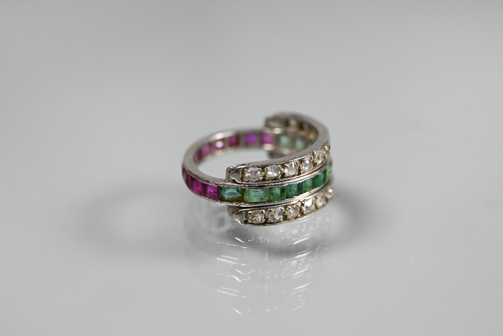 A trio 'Day/Night' ring, white metal set with channel set diamonds, rubies and emeralds, size M