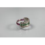 A trio 'Day/Night' ring, white metal set with channel set diamonds, rubies and emeralds, size M