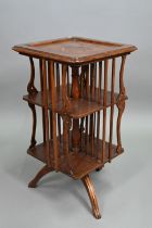 An continental Art Nouveau period floral marquetry inlaid walnut revolving bookcase, raised on a