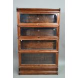 An oak Globe Wernicke graduated four-tier library bookcase, on a shaped plinth base, 87 cm x 27 cm x