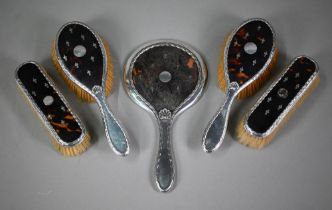 A silver and tortoiseshell picquet-work five-piece brush set including hand-mirror, Levi &