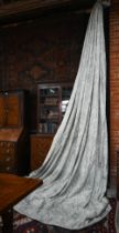 A pair of long country house curtains in pale grey with stylised acanthus leaf decoration, triple