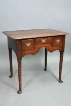 An 18th century oak three drawer side table, raised on turned legs to pad feet, 76 cm w x 51 cm x 71