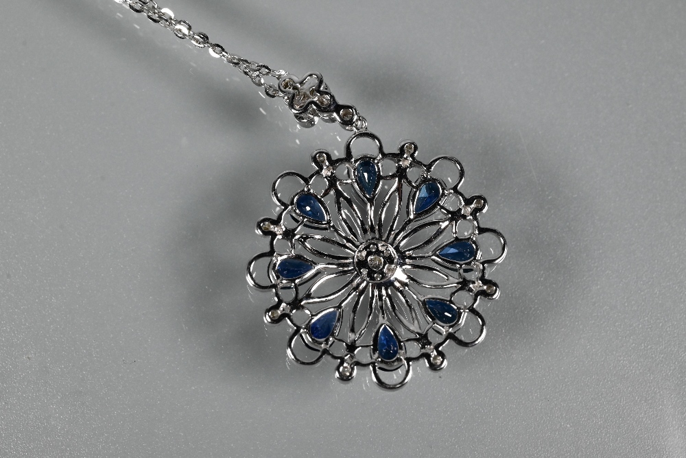 A sapphire and diamond pendant, the open circular millgrain wirework flower-style mount set with - Image 5 of 5