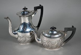 A late Victorian silver tea pot and coffee pot with composite handles and ebonised finials, James