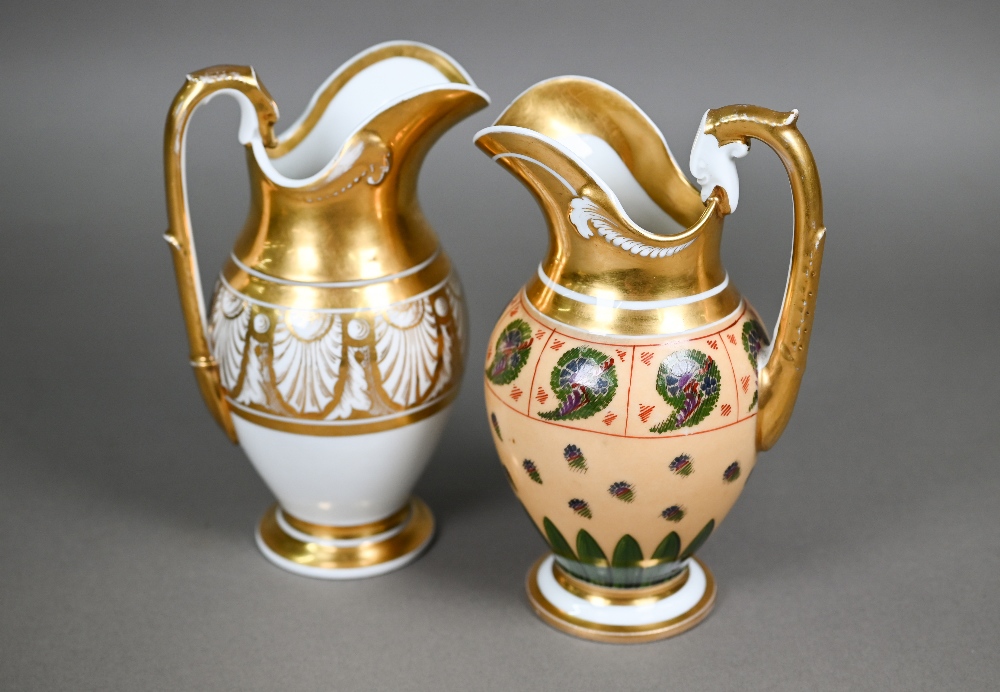 Two Empire Period Paris porcelain gilded jugs of matching shape, with extensive gilding - one