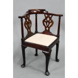 A Georgian mahogany corner chair, with twin pierced vase shape splats flanked by turned pilasters,